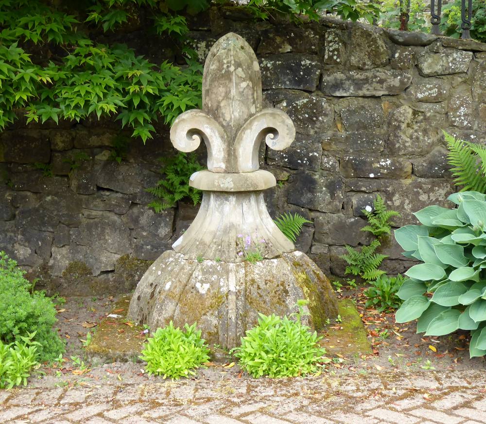 The fleur-de-lys of Stockbriggs House used as a feature in the walled garden